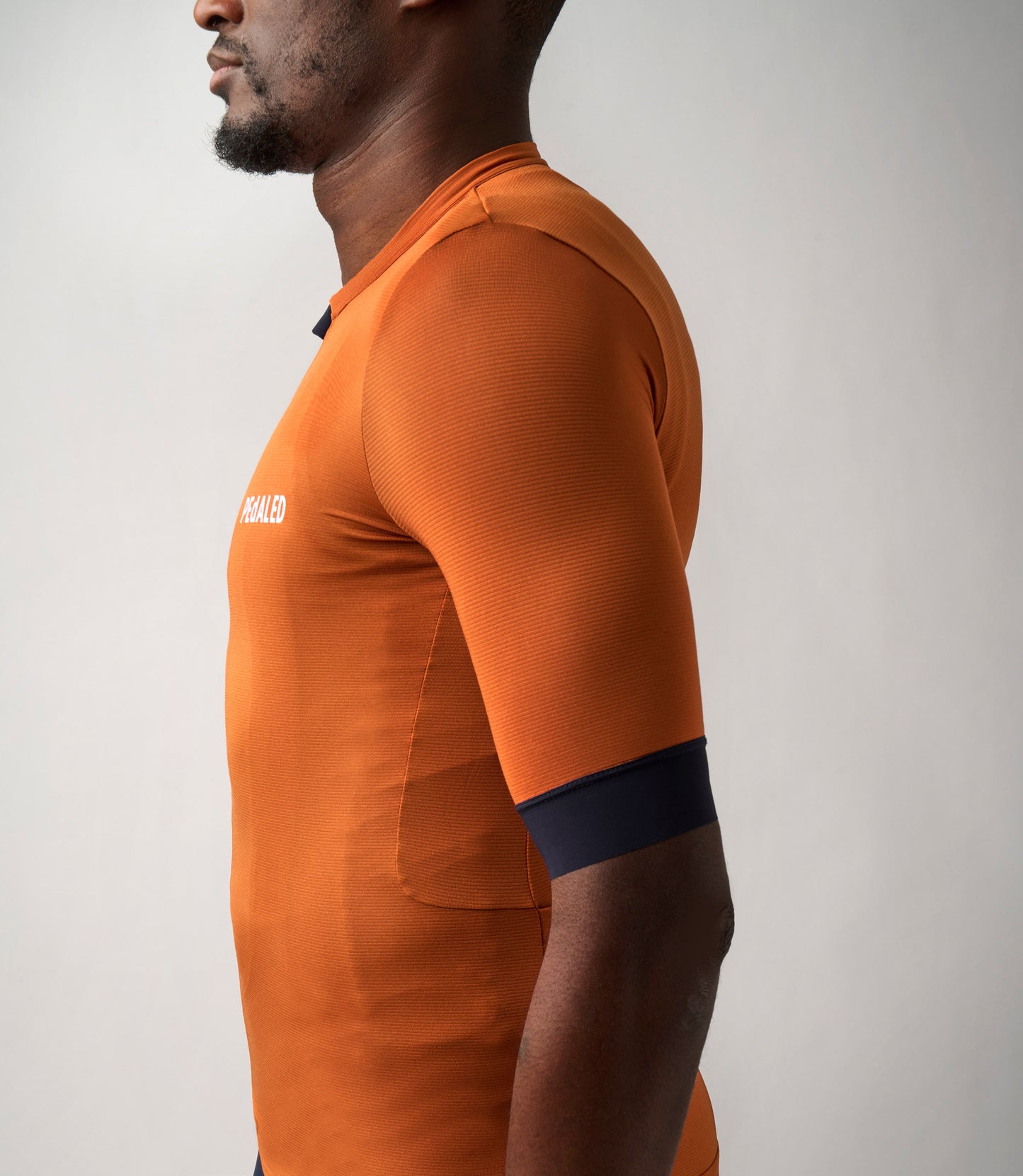 23SJSES0HPE_8_men cycling jersey orange essential side pedaled