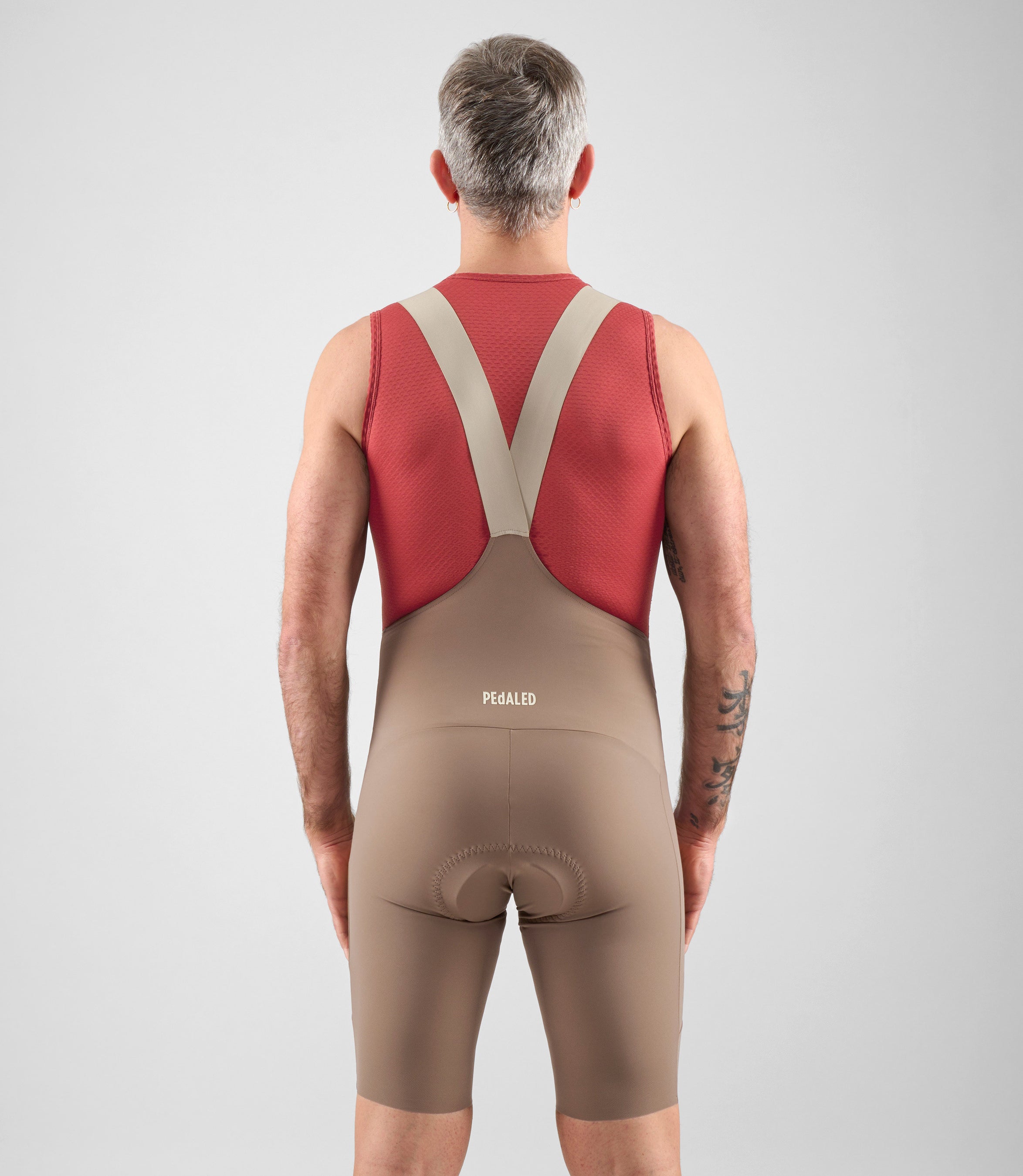 24SBLEL75PE_4_men cycling baselayer element dark red total body back pedale