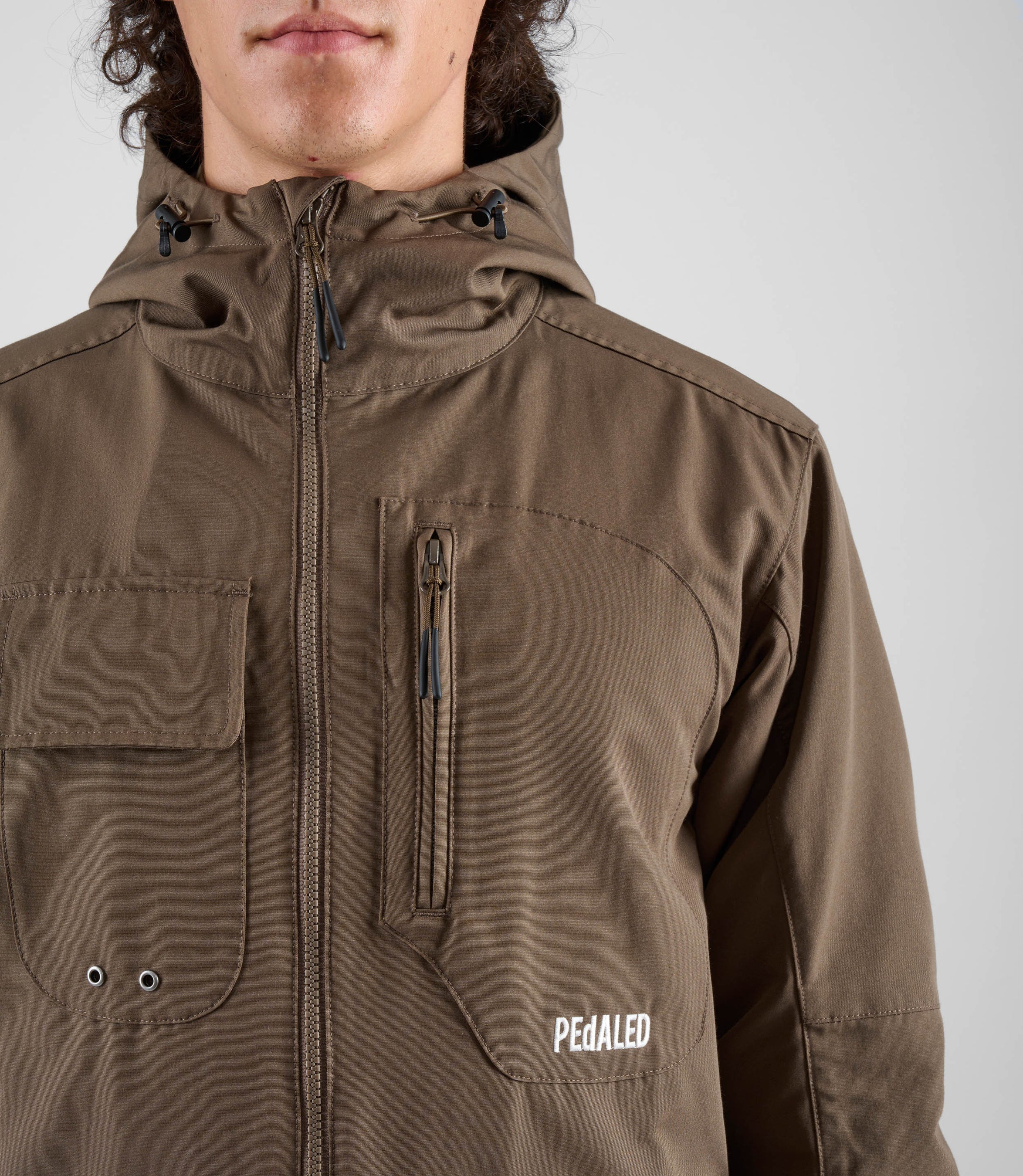 24WJKUR14PE_5_men cycling hooded jacket brown urban front pocket pedaled