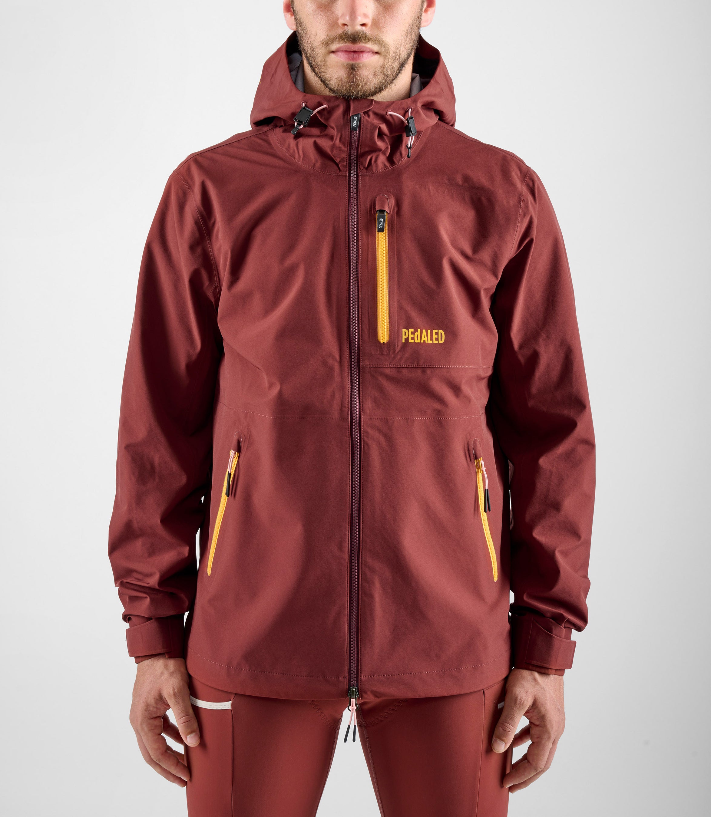 24WSJOD75PE_8_men cycling waterproof shell jacket red odyssey front pedaled