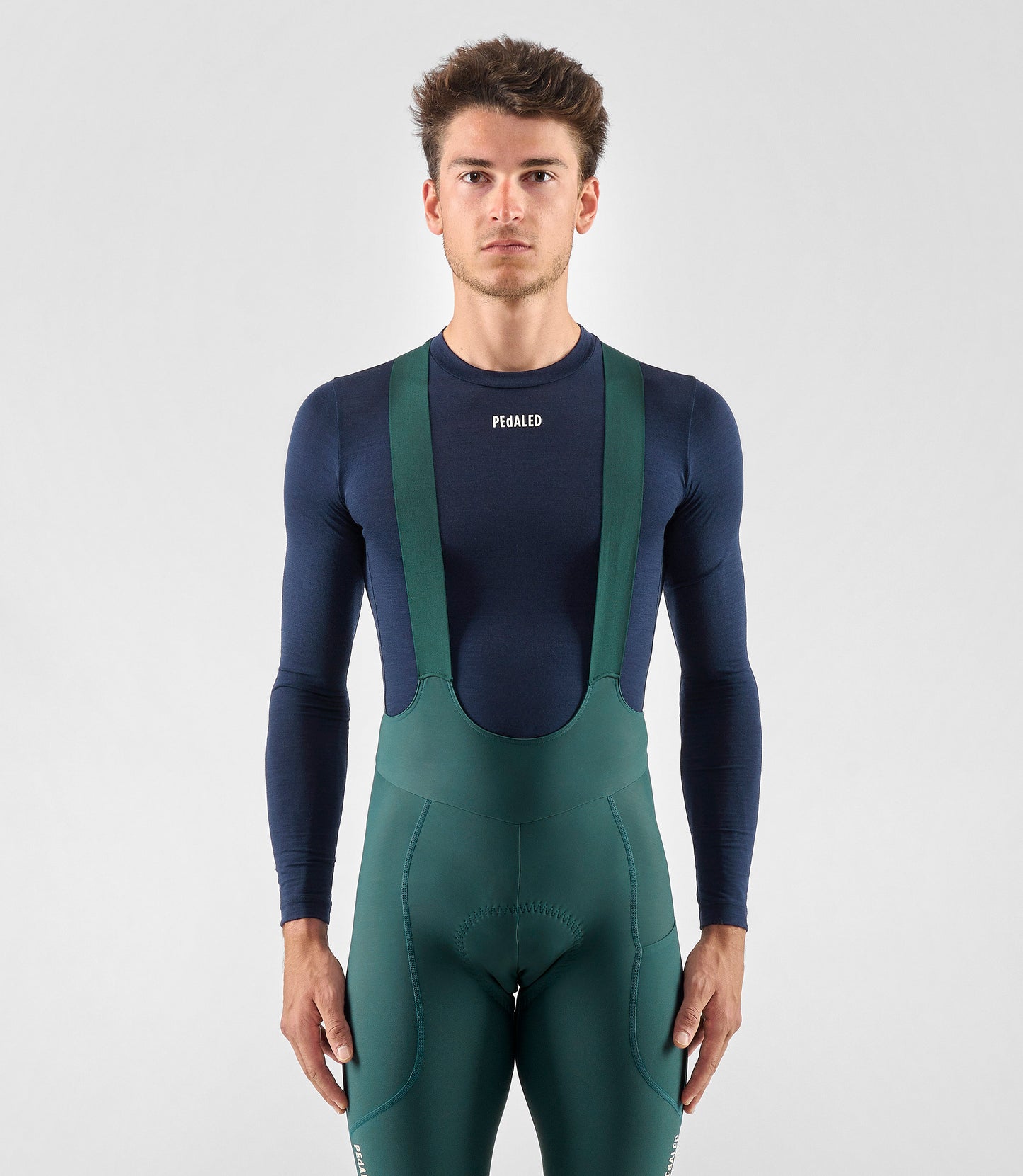 25WMBEL74PE_3_men cycling merino base layer dark navy element total body front pedaled