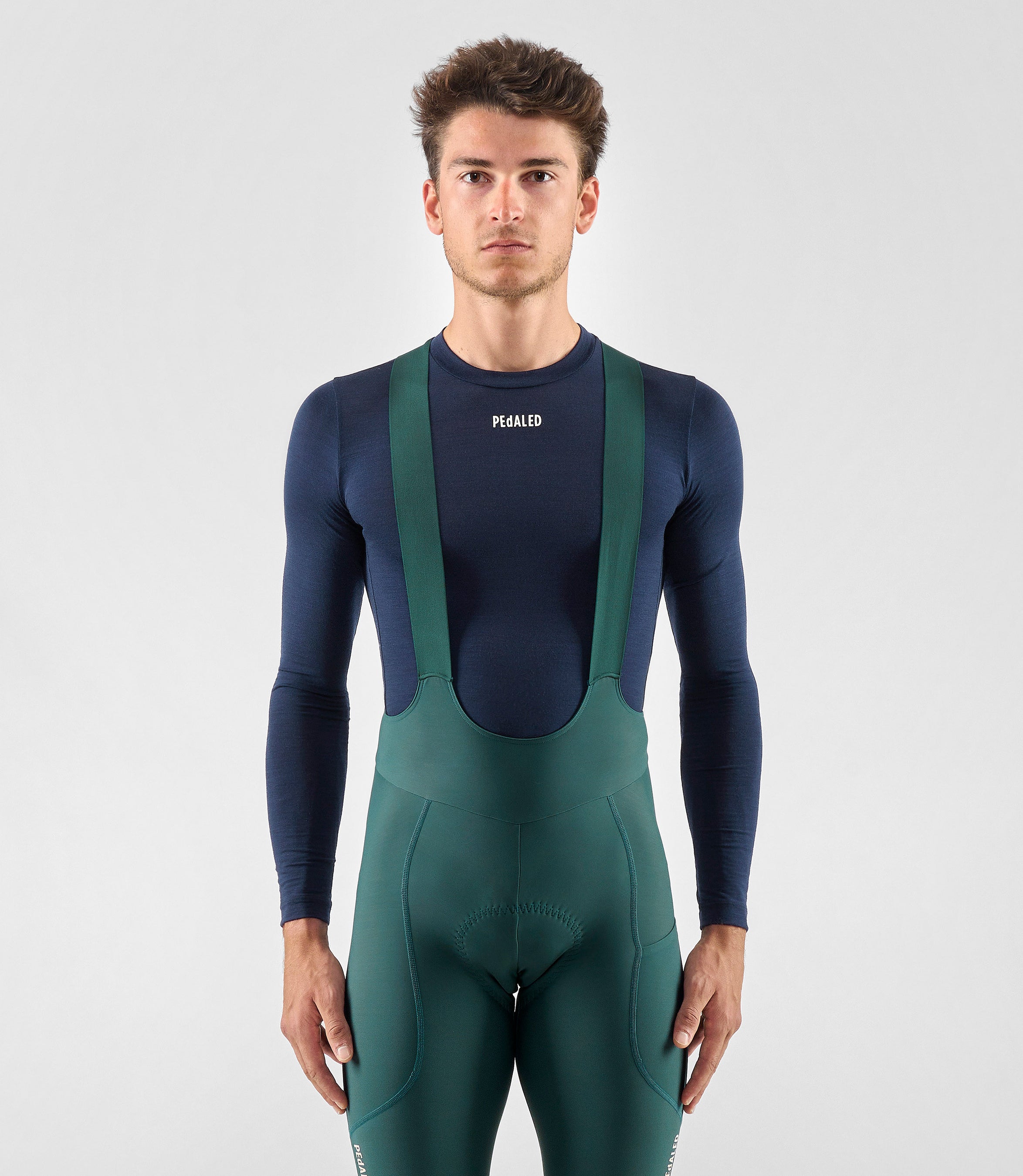 25WMBEL74PE_3_men cycling merino base layer dark navy element total body front pedaled