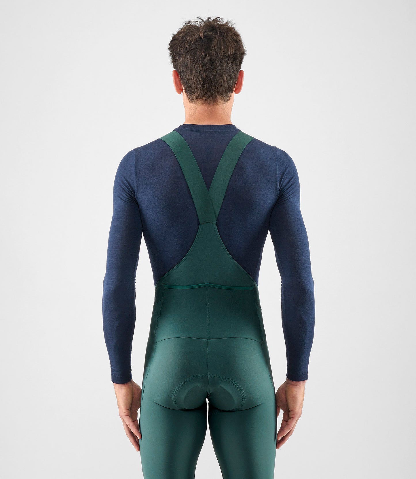 25WMBEL74PE_4_men cycling merino base layer dark navy element total body back pedaled