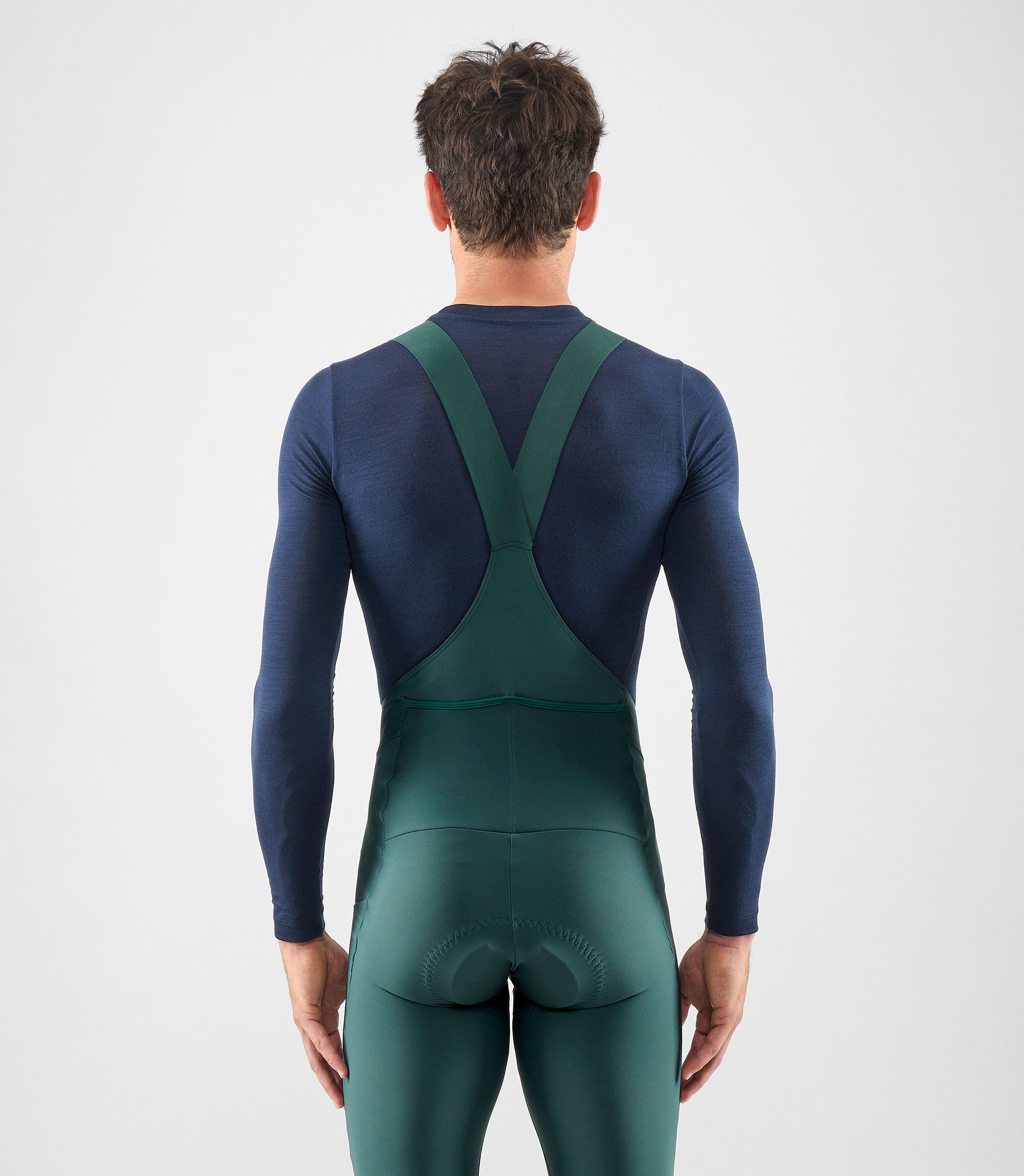 25WMBEL74PE_4_men cycling merino base layer dark navy element total body back pedaled