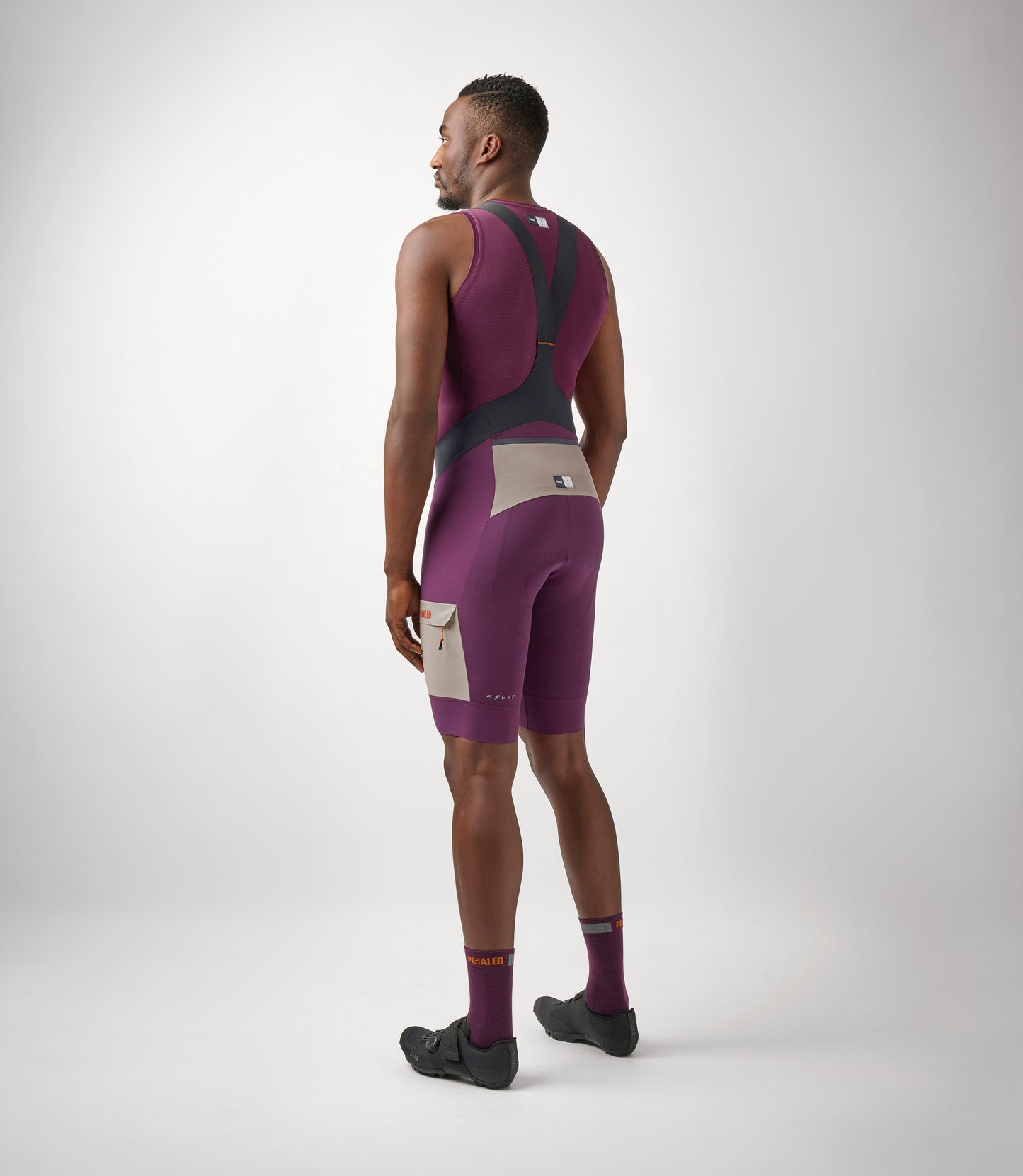 23SBBOD10PE_4_men cycling cargo bibshort purple odyssey total body back pedaled