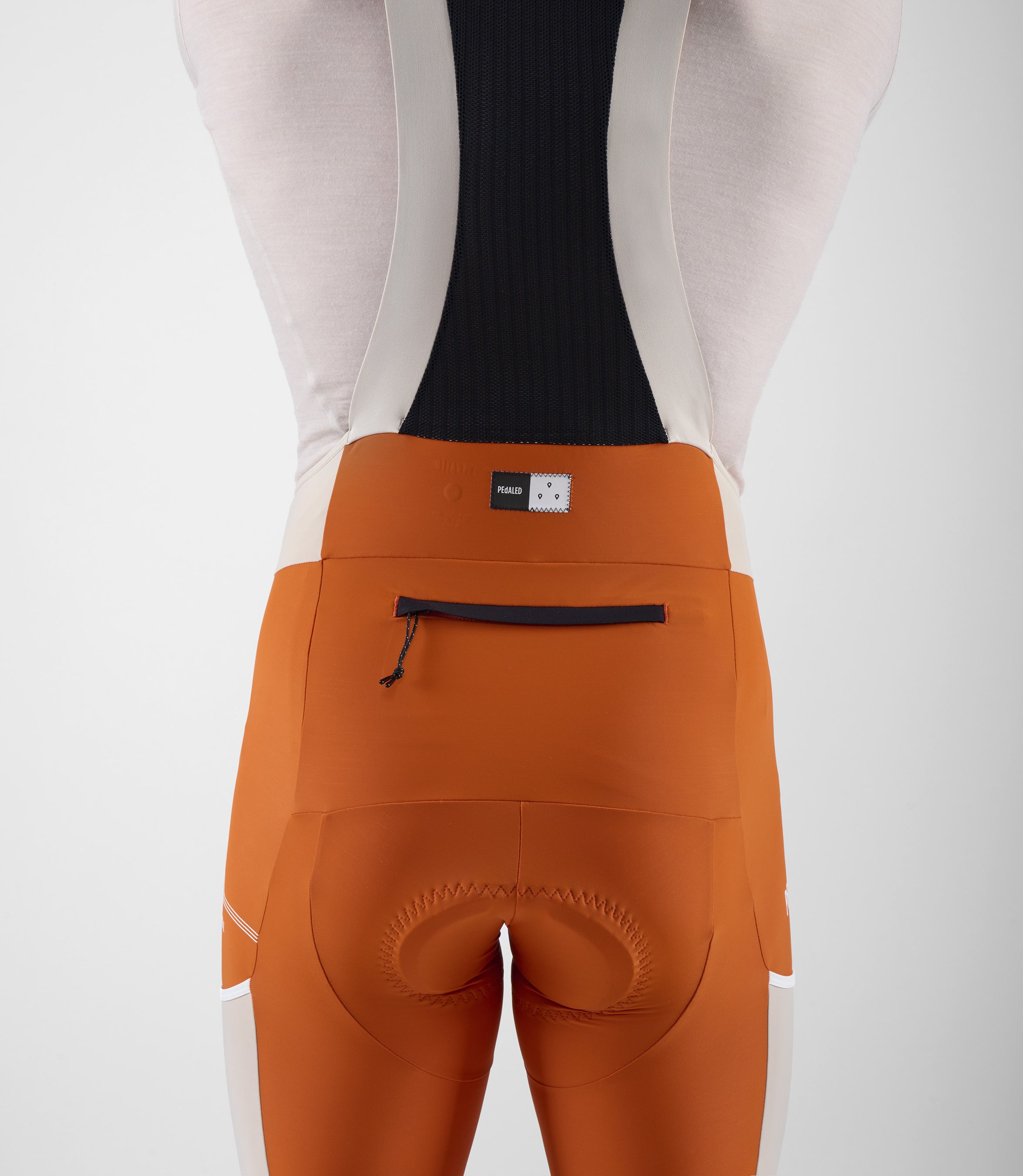 23SBBTC12PE_10_men cycling bib shorts transcontinental orange back pocket pedaled