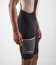 24SBBOD00PE_7_men cycling cargo bibshort black odyssey right pocket pedaled