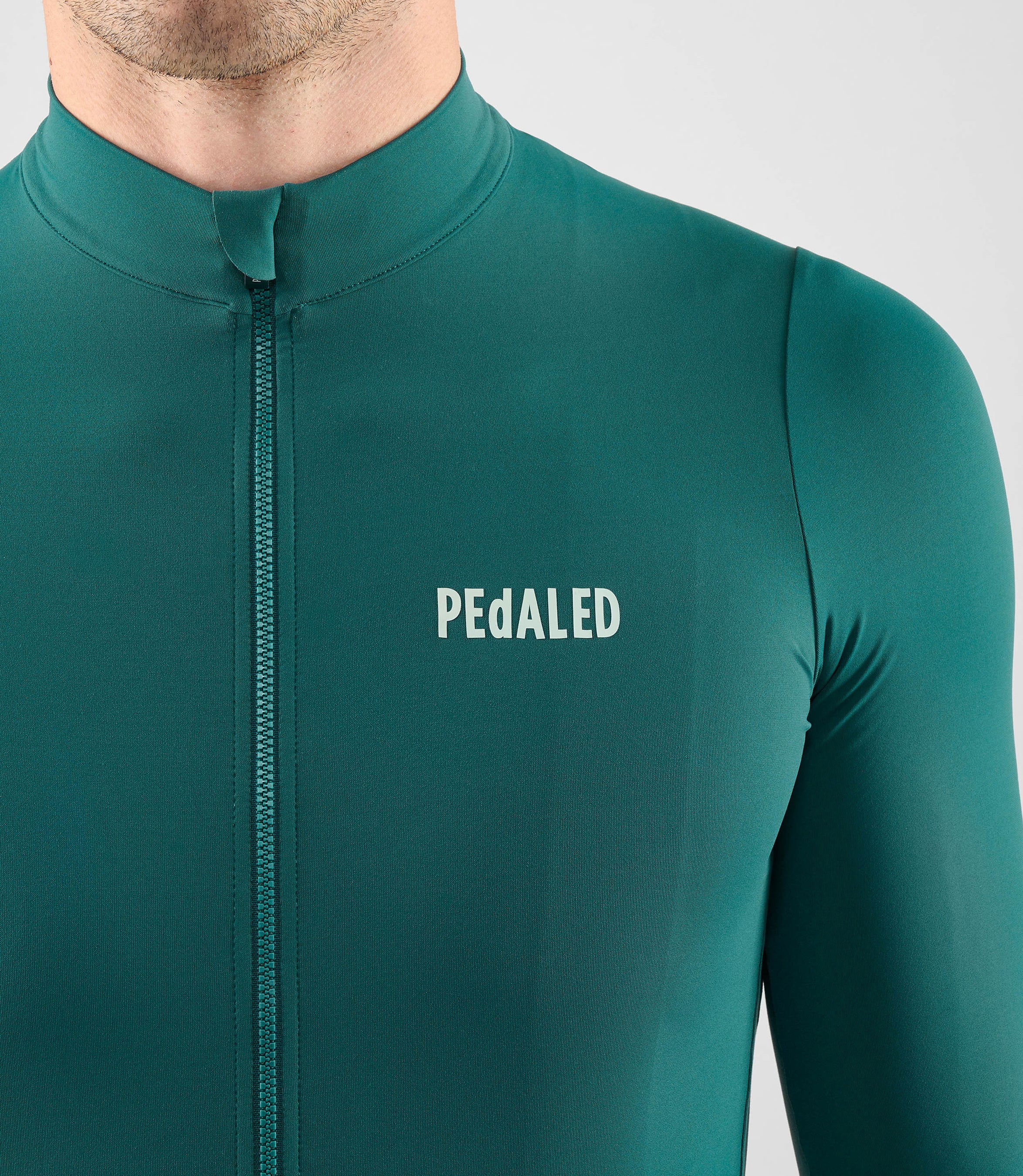 25WJSEL18PE_5_men cycling jersey long sleeve teal element front pedaled