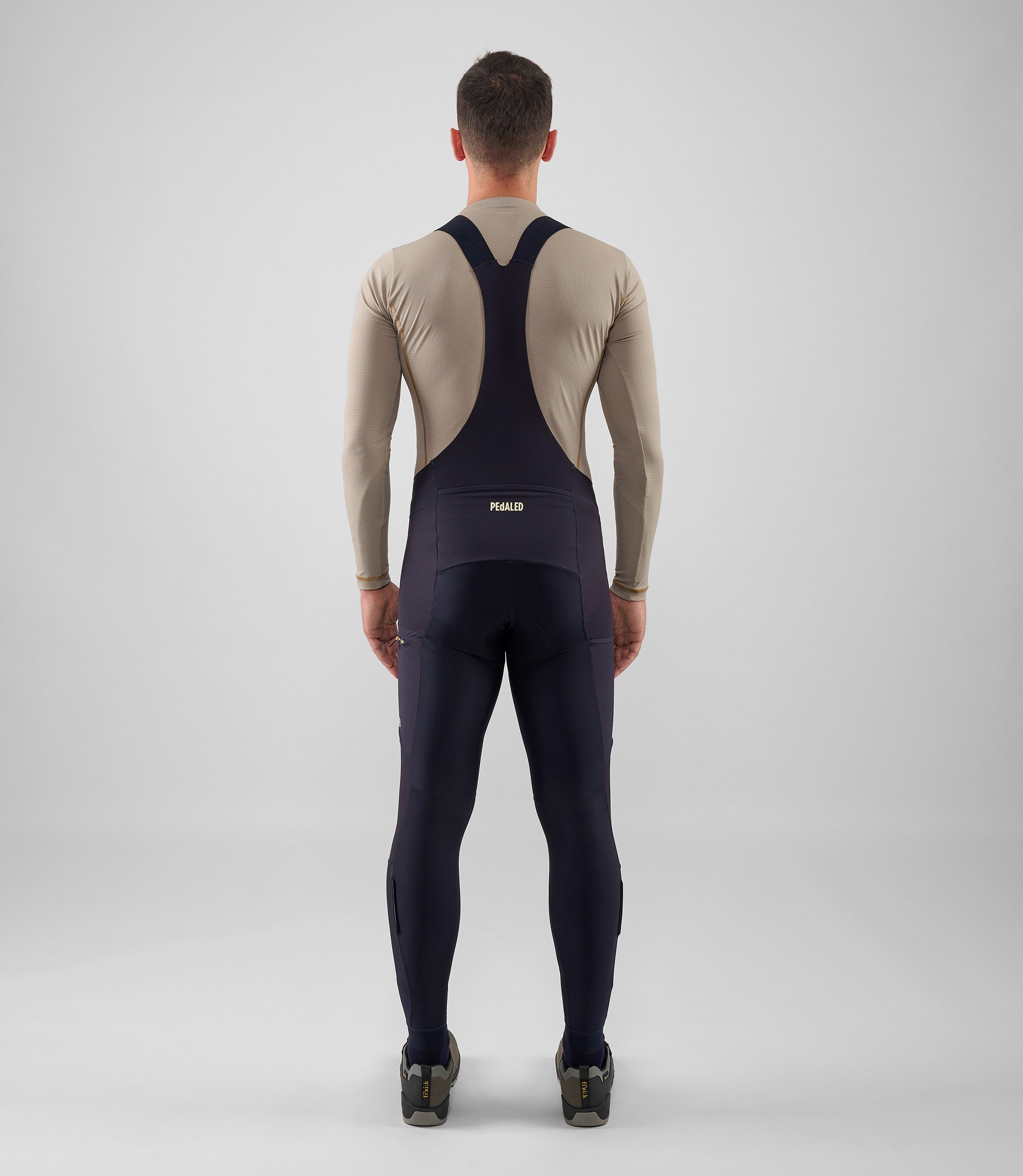 25WWTOD74PE_4_men cycling cargo bib tight dark navy odyssey total body back pedaled