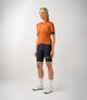 W3SJSES0HPE_3_women cycling jersey essential orange total body front pedaled
