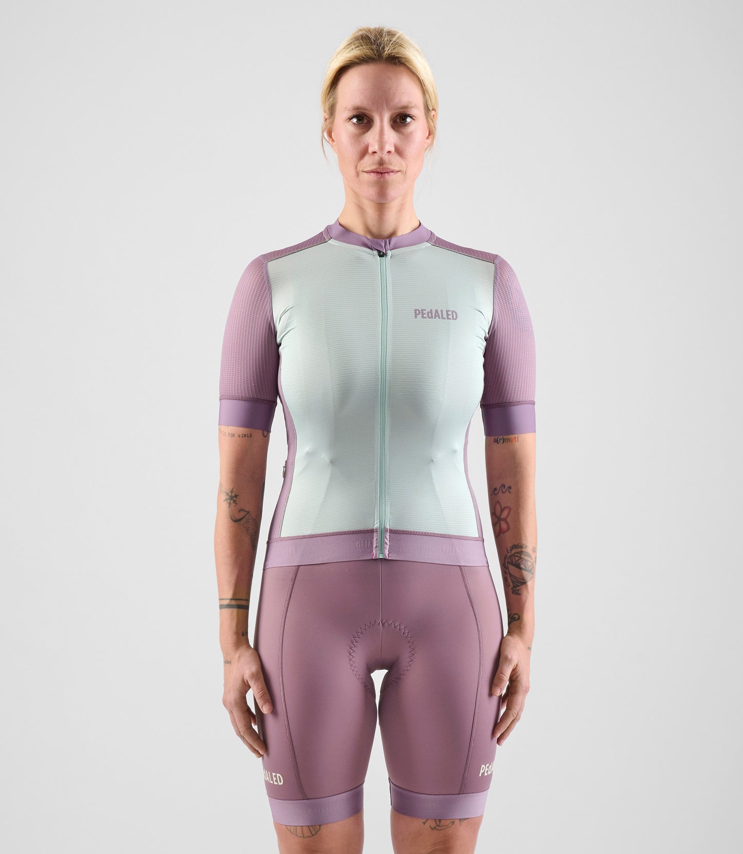 W4SJSEL0IPE_3_women cycling jersey element lilac total body front pedaled