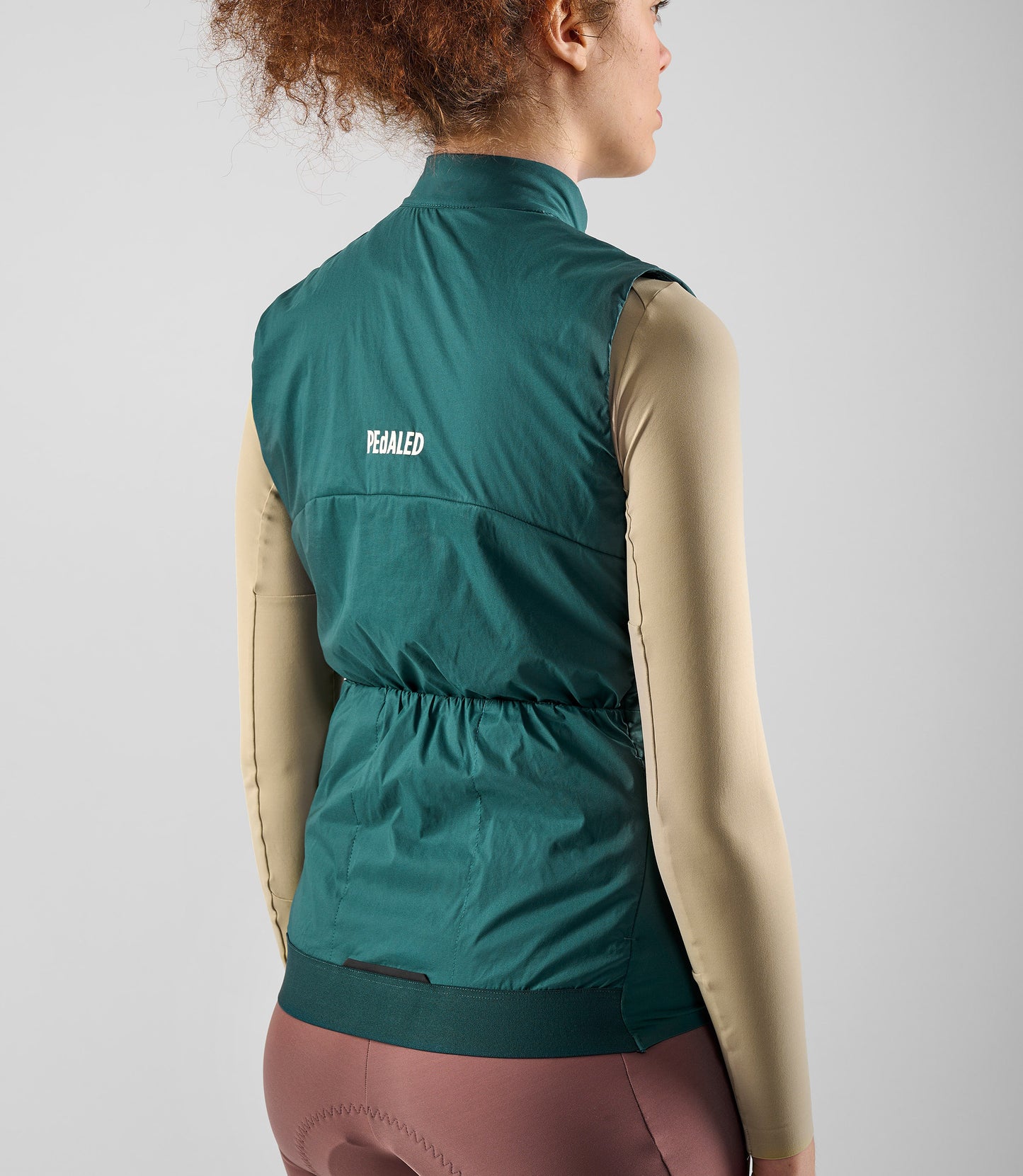 W5WAVEL18PE_5_women cycling vest alpha teal element back pocket pedaled
