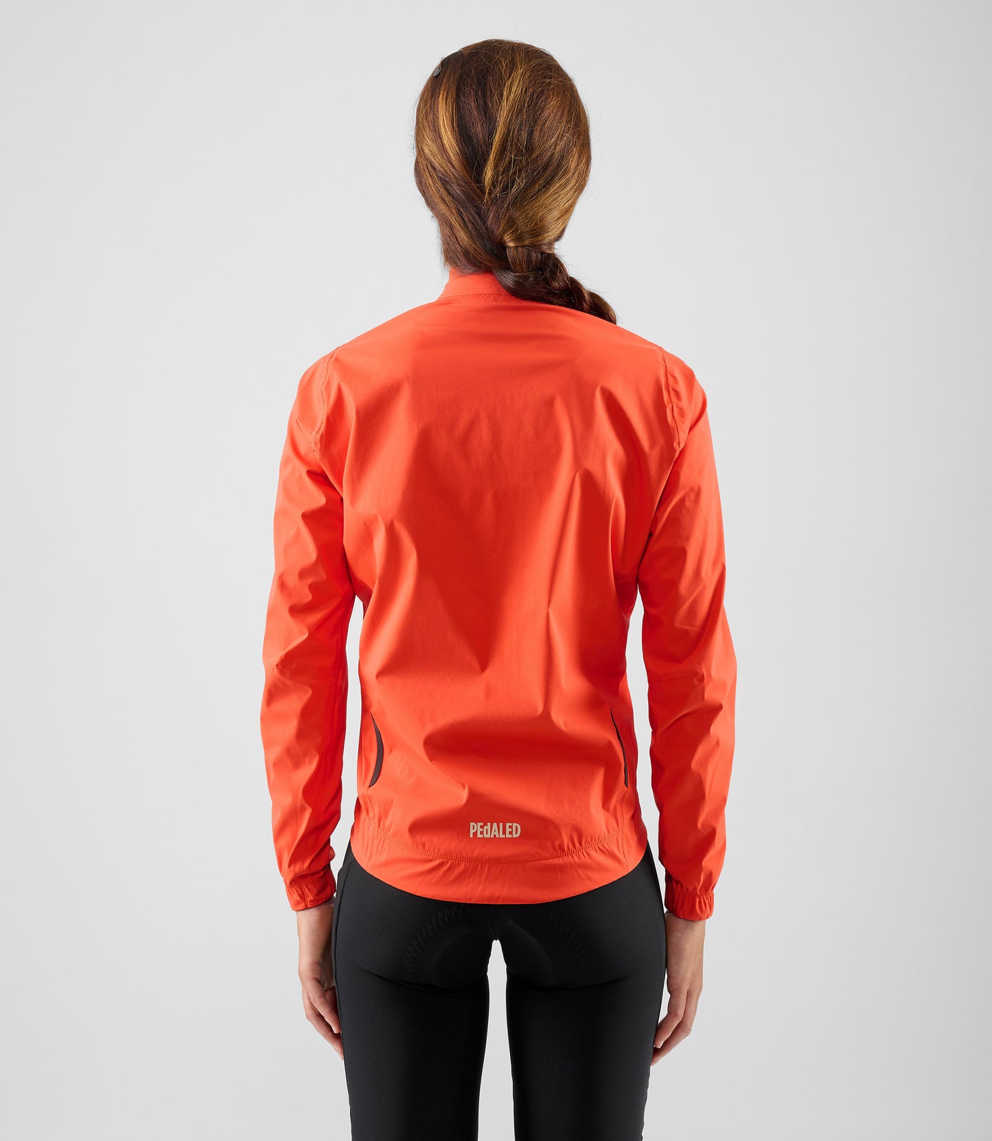 W5WWJEL12PE_4_women cycling waterproof jacket orange element total body back pedaled