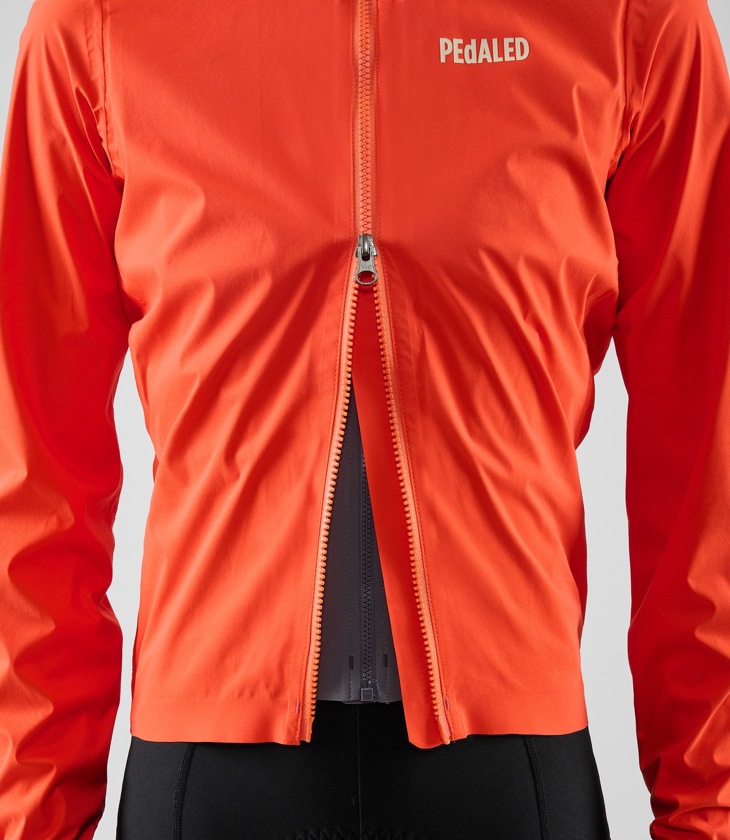W5WWJEL12PE_8_women cycling waterproof jacket orange element double zip pedaled