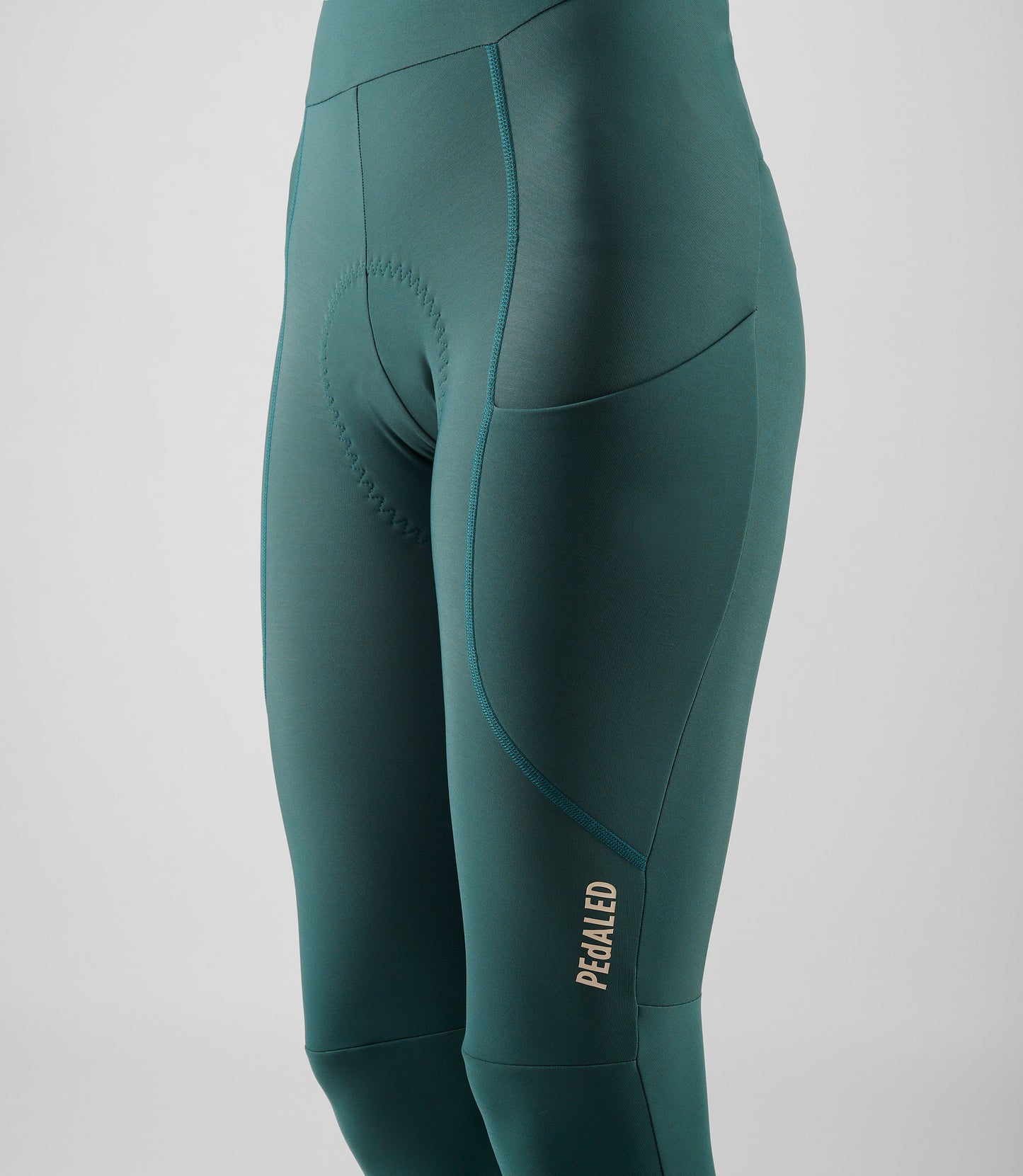 W5WWTEL18PE_5_women cycling bibtight teal element side logo pedaled